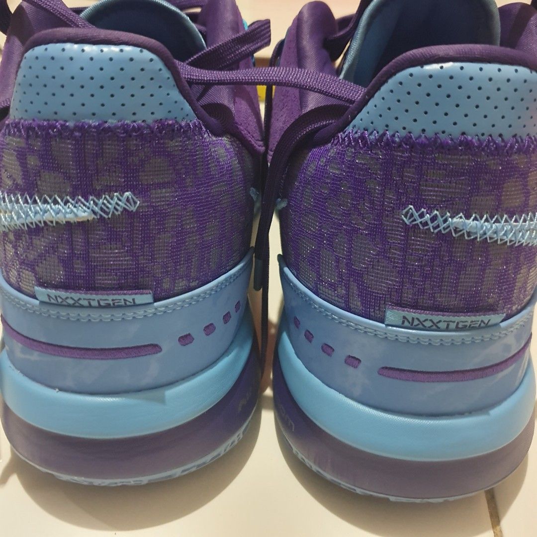Nike Zoom LeBron NXXT Gen (Category: Sneakers) located in Manila. Submitted by wasdxyz (Listing ID 1424800855, Image 3). Description: These Nike Zoom NXT Gen basketball shoes feature a vibrant purple and blue color scheme. The shoes have a suede upper with a mesh panel and a Nike swoosh logo. The soles are a combination of blue and purple. The shoes have laces and a padded collar for comfort. The model name is visible on the side of the shoe..