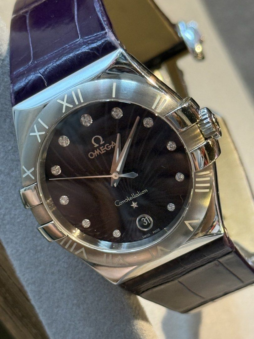 Omega Constellation Diamond Watch (Category: Luxury Watches) located in Manila. Submitted by ahmazing (Listing ID 1424798036, Image 3). Description: - Omega Constellation watch - Dark dial with diamond hour markers - Stainless steel case - Purple leather strap/Supernova - Date display at 3 o'clock - Constellation logo on the back - Deployment clasp with Omega logo - Ref. No.: 123.13.35.60.60.001 - Box and Receipt - Country of Purchase: 🇯🇵.