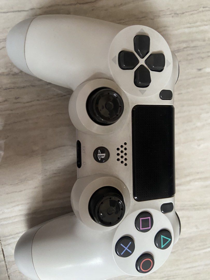 PlayStation 4 Slim 1tb (Category: PlayStation) located in Caloocan City. Submitted by ss_kai (Listing ID 1424741031, Image 3). Description: Includes a PlayStation 4 console, two black controllers, and one white controller. Also comes with a charging dock for the controllers. The bundle includes five games: Crash Bandicoot N. Sane Trilogy, Tekken 7, God of War, Detroit: Become Human, and The Last of Us Remastered. Comes with the original box of th