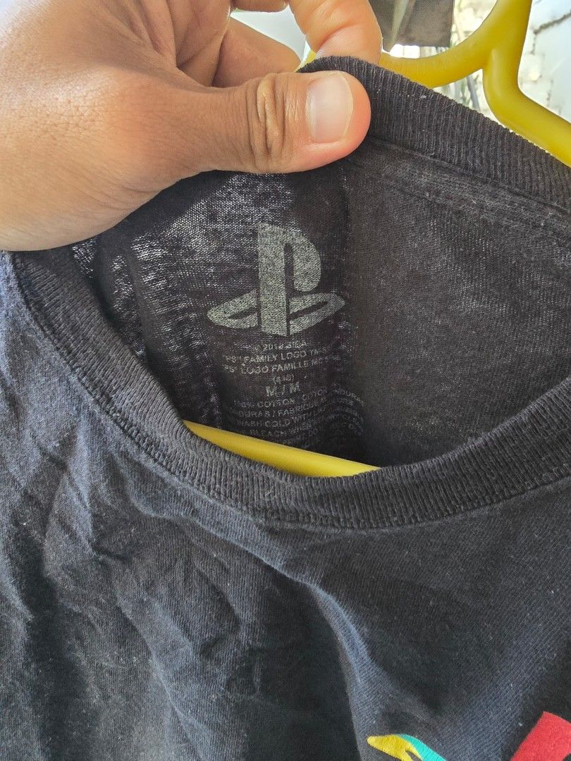 PlayStation Long Sleeve Shirt (Category: Tshirts & Polo Shirts ) located in Puerto Princesa. Submitted by palawan_vintage (Listing ID 1424882639, Image 2). Description: Black long sleeve shirt featuring the PlayStation logo on the front and controller button symbols on the sleeves. The shirt has a crew neck. The tag is visible in the image..