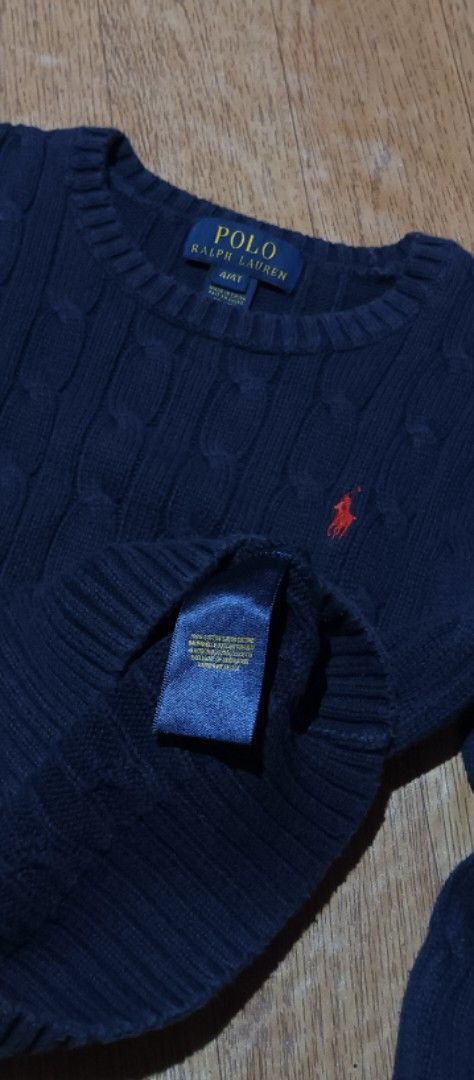 Polo Ralph Lauren Cable Knit Sweater 4T (Category: Babies & Kids Fashion) located in Quezon City. Submitted by mangthrift (Listing ID 1424856870, Image 3). Description: - Polo Ralph Lauren sweater - Dimes 13/16 (kids) - Color: Navy blue - Size: 4T - Design: Cable knit - Features the Polo Ralph Lauren logo - Neckline: Crew neck - Sleeves: Long - Material: Soft knit, ideal for cooler weather.