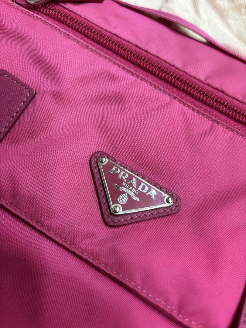 Prada Vela Messenger Bag - Fuxia (Category: Luxury Bags & Wallets) located in Sorsogon. Submitted by thriftychad (Listing ID 1424815990, Image 2). Description: - Authentic Prada Vela Messenger Bag - Color: Fuchsia - Material: Nylon with leather accents - Hardware: Silver-tone - Features: - Detachable shoulder strap - Interior zip pocket - Prada logo plaque - Includes: Authenticity cards and dust bag - Closure: Zip - Strap: Adjustable.