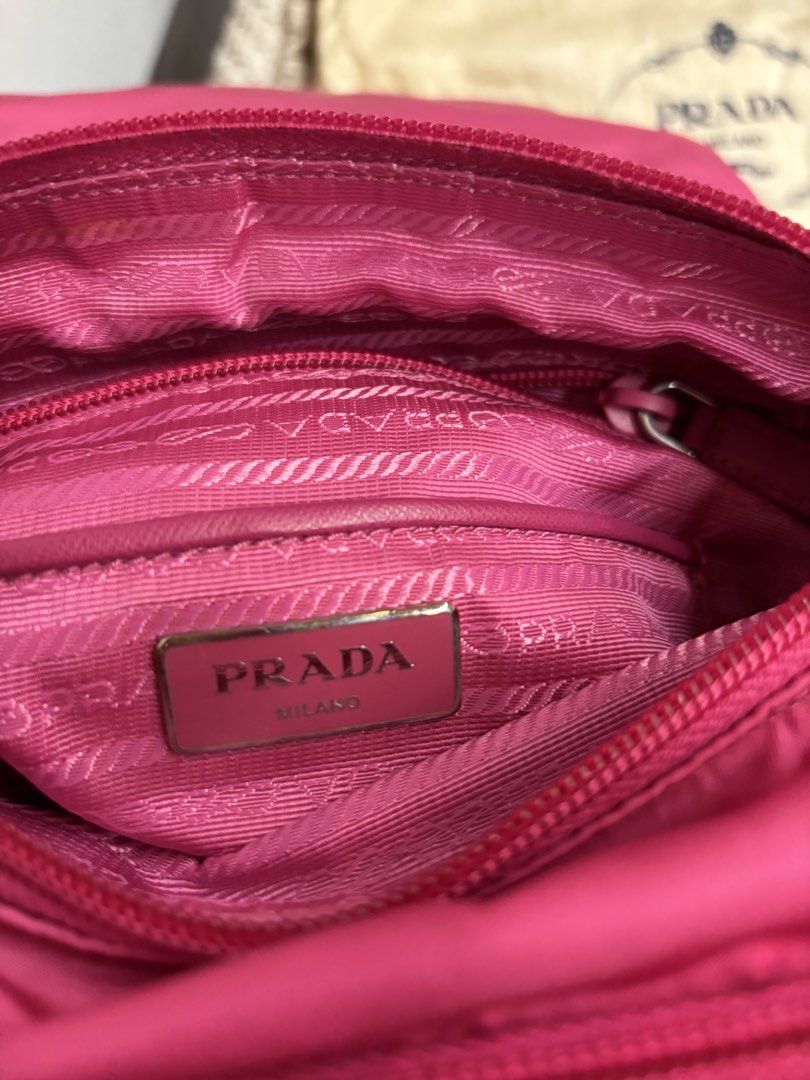 Prada Vela Messenger Bag - Fuxia (Category: Luxury Bags & Wallets) located in Sorsogon. Submitted by thriftychad (Listing ID 1424815990, Image 3). Description: - Authentic Prada Vela Messenger Bag - Color: Fuchsia - Material: Nylon with leather accents - Hardware: Silver-tone - Features: - Detachable shoulder strap - Interior zip pocket - Prada logo plaque - Includes: Authenticity cards and dust bag - Closure: Zip - Strap: Adjustable.