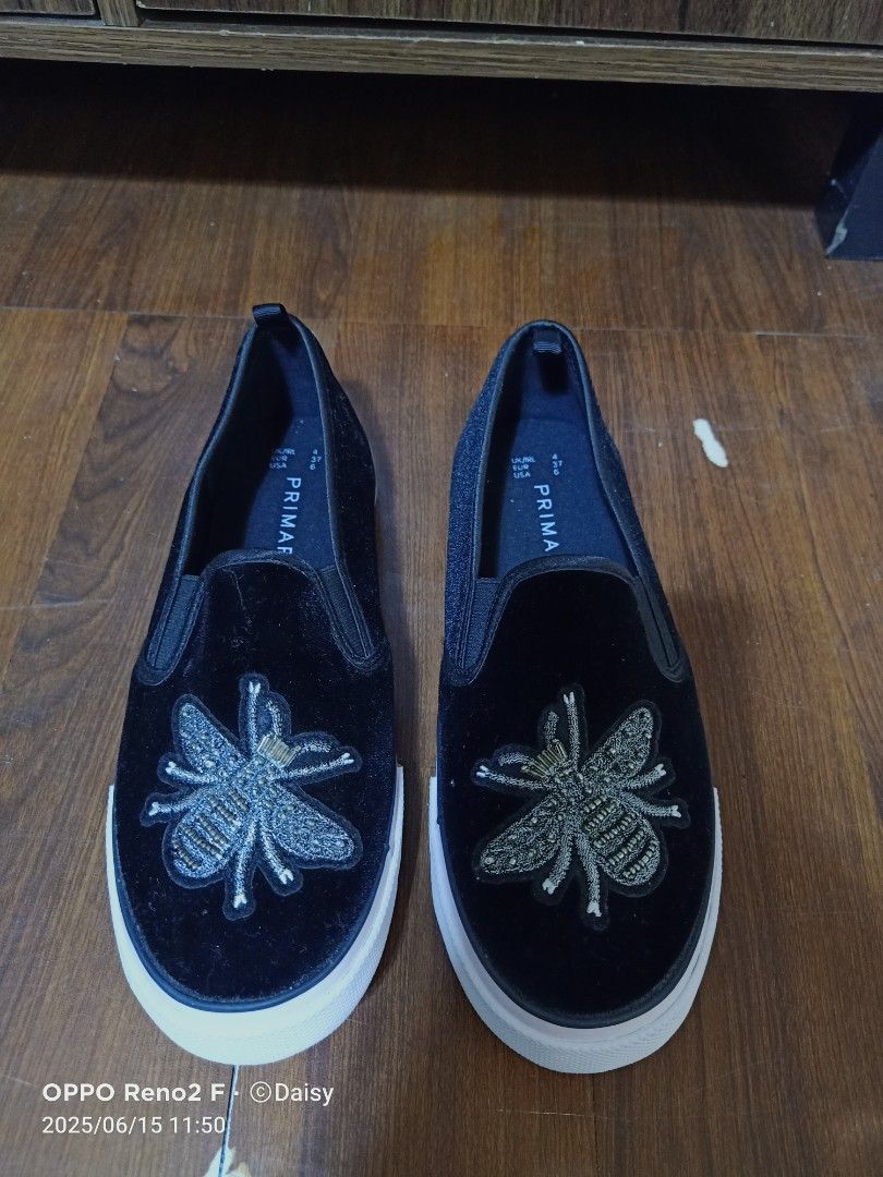Primark Bee Embellished Slip-on Shoes (Category: Sneakers) located in Quezon City. Submitted by uydaisy1979 (Listing ID 1424758415, Image 1). Description: Black slip-on shoes from Primark. Features a bee embroidery on the front. The shoes have a white sole..