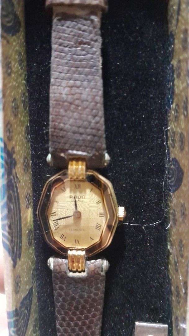 Rado Florence Watch (Category: Luxury Watches) located in San Pedro. Submitted by resa70 (Listing ID 1424753282, Image 2). Description: Elegant Rado Florence watch with a gold-toned octagonal face and a brown leather strap. The watch is presented in its original box, which has a decorative design. The watch face features Roman numeral hour markers and the Rado logo. The back of the watch shows the model number. Vintage Rado ladies watch. from Jap