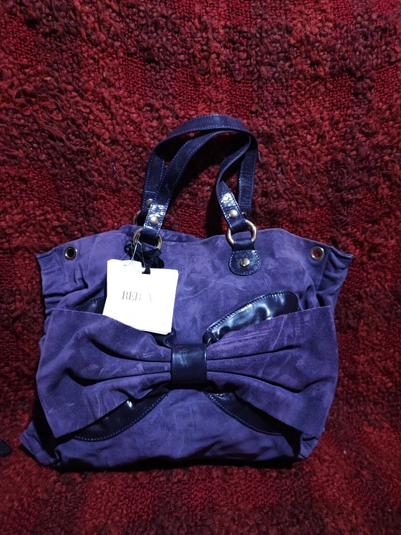 Red Valentino Purple Suede Handbag (Category: Luxury Bags & Wallets) located in Baguio. Submitted by ozara.06 (Listing ID 1424711363, Image 1). Description: Red Valentino Medium size New with tag Suede material Missing sling strap 1300.