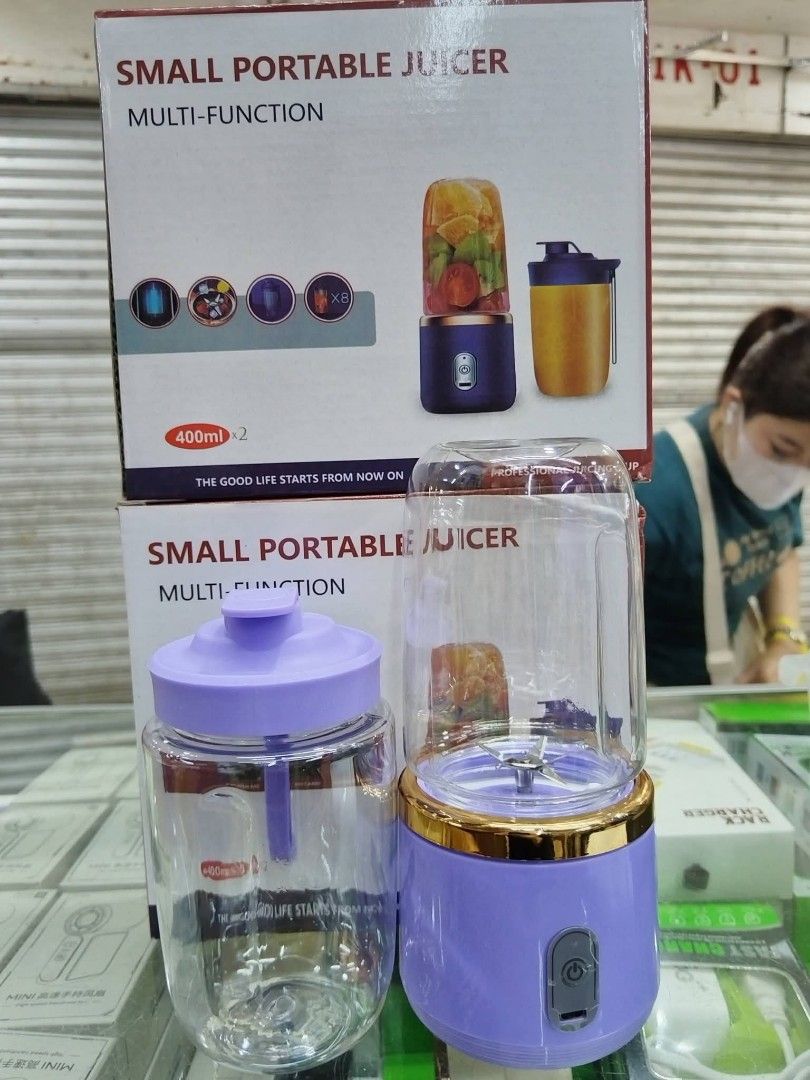 Small Portable Multi-Function Juicer (Category: Juicers, Blenders & Grinders) located in Manila. Submitted by haideshop (Listing ID 1424877092, Image 1). Description: Small portable juicer is multi-functional. It comes with a 400ml capacity cup and a separate container. The juicer has a purple base with a gold trim. It includes a lid for the cup. The images show how to cut ingredients, add water or milk, and use the start button. It is designed f