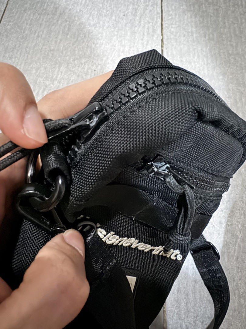 thisisneverthat x New Era Crossbody Bag (Category: Sling Bags) located in Mandaluyong City. Submitted by de_keein (Listing ID 1424868856, Image 3). Description: Black crossbody bag from thisisneverthat in collaboration with New Era. Features a main zippered compartment and an exterior pocket. Includes an adjustable strap with the thisisneverthat logo. The bag has a small New Era logo patch on the front. The interior tag provides additional detail