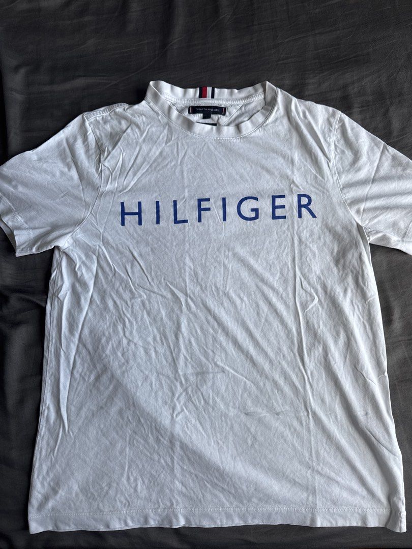 Tommy Hilfiger White T-shirt (Category: Tshirts & Polo Shirts ) located in Makati City. Submitted by fraankiee (Listing ID 1424764882, Image 1). Description: Width - 45cm Length - 68cm.