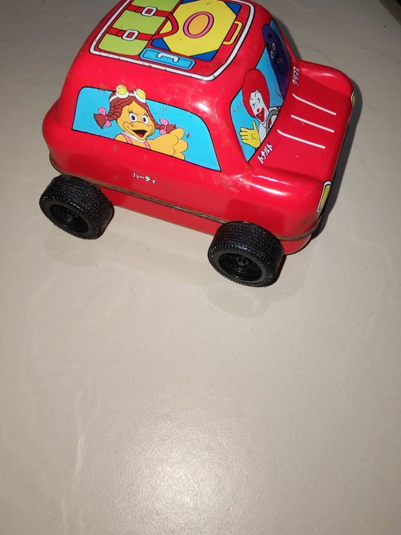 Vintage McDonald's Toy Car (Category: Vehicle & Diecast Models) located in Taguig. Submitted by tresfilijapanuksurplus (Listing ID 1424826792, Image 3). Description: - Vintage McDonald's toy car - Features Ronald McDonald, Grimace, and other characters - Red color - Metal construction - Black wheels - Luggage design on roof.