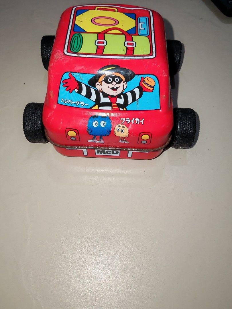 Vintage McDonald's Toy Car (Category: Vehicle & Diecast Models) located in Taguig. Submitted by tresfilijapanuksurplus (Listing ID 1424826792, Image 2). Description: - Vintage McDonald's toy car - Features Ronald McDonald, Grimace, and other characters - Red color - Metal construction - Black wheels - Luggage design on roof.