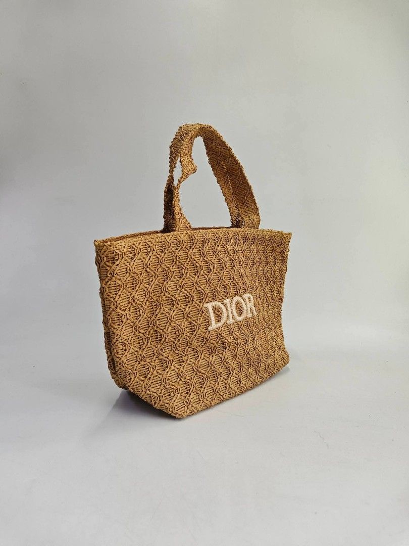 👑VIP Dior Woven Tote Bag mini (Category: Luxury Bags & Wallets) located in Quezon City. Submitted by elegantephbycharlie (Listing ID 1424758318, Image 2). Description: Woven tote bag features the Dior logo embroidered on the front. It has two top handles and a spacious interior. The bag is made of a woven material and has a light brown color. The interior lining is a light pink color. It is a stylish and practical accessory..