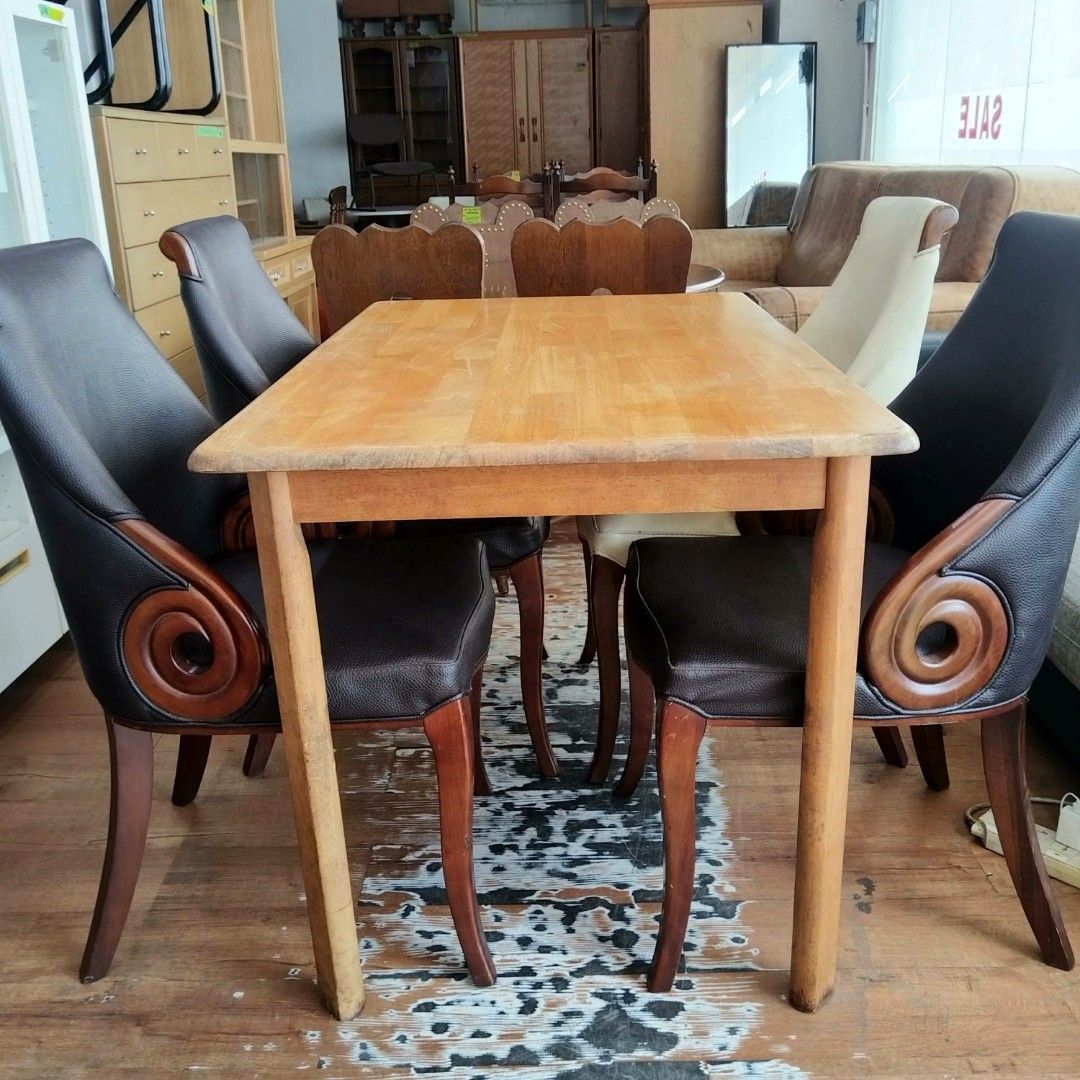 2nd hand Wooden Dining Table with 4 Chairs 5pcs set (Category: Tables & Sets) located in Paranaque City. Submitted by feybelhaft (Listing ID 1424965792, Image 3). Description: Elegant wooden dining table with four matching chairs. The chairs feature a unique design with curved backs and armrests. The table has a rectangular shape with a light wood finish. This set is perfect for a dining room or kitchen. The chairs have a mix of light and dark up
