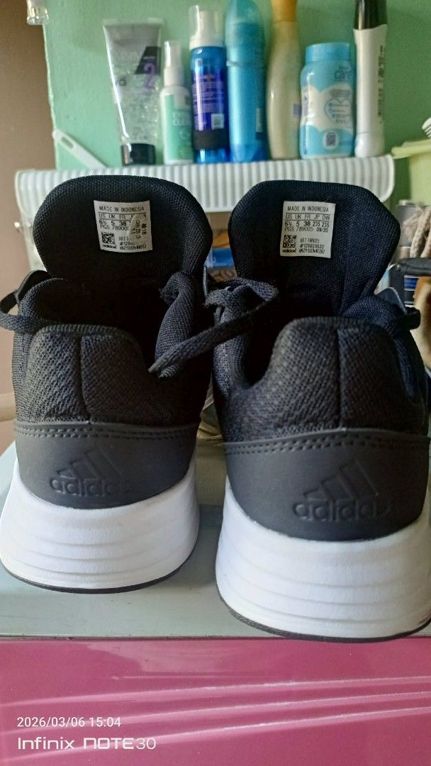 Adidas Galaxy 5 Black Running Shoes (Category: Sneakers) located in Caloocan City. Submitted by _bhprelab (Listing ID 1424949854, Image 2). Description: Original like new nneds konting linis 2x lng nagamit Adidas Galaxy 5 running shoes in black. Features the Adidas logo on the tongue and heel. The shoes have white stripes on the sides and a white sole. The shoes have black laces..