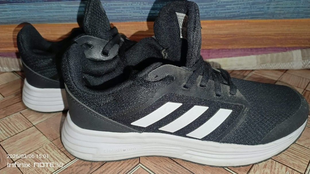 Adidas Galaxy 5 Black Running Shoes (Category: Sneakers) located in Caloocan City. Submitted by _bhprelab (Listing ID 1424949854, Image 3). Description: Original like new nneds konting linis 2x lng nagamit Adidas Galaxy 5 running shoes in black. Features the Adidas logo on the tongue and heel. The shoes have white stripes on the sides and a white sole. The shoes have black laces..