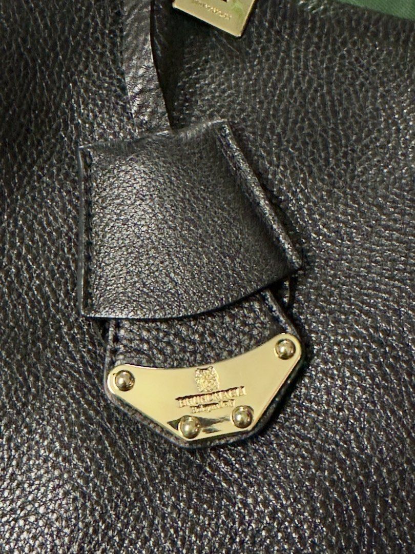Bruno Magli Black Leather Tote Bag (Category: Luxury Bags & Wallets) located in Angeles City. Submitted by ritenianstuff (Listing ID 1424973727, Image 3). Description: Genuine leatherblack tote bag by Brunomagli. Features a spacious interior with multiple compartments and a zip closure. Includes a detachable leather tag with the brand's logo. The bag has double handles with a unique design. The interior lining has a branded pattern. Gold hardware
