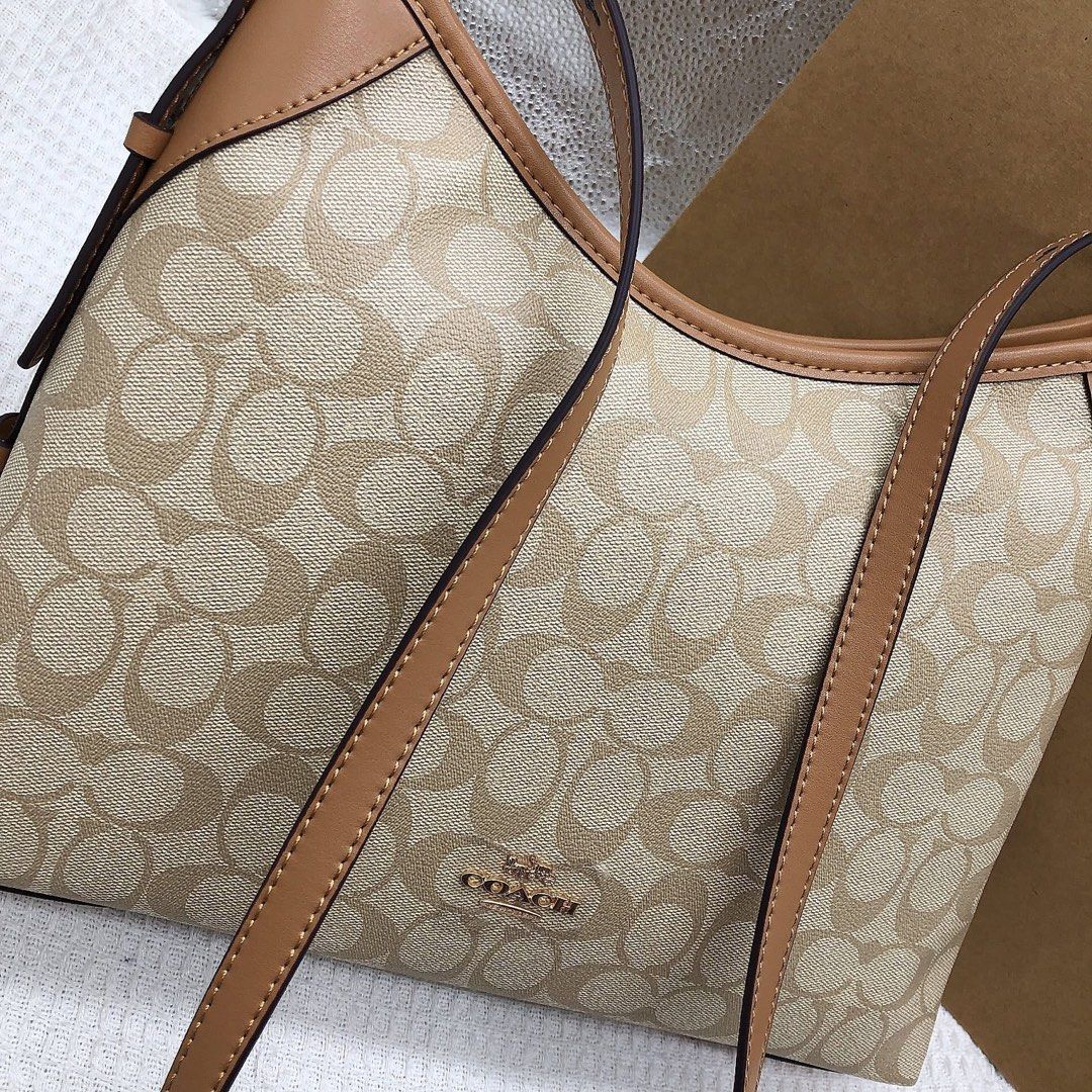 Coach Signature Shoulder Bag (Category: Luxury Bags & Wallets) located in Manila. Submitted by clairetot (Listing ID 1424912751, Image 2). Description: Coach shoulder bag with signature pattern. Features a zip closure and an interior pocket. Includes a detachable strap. The bag has a brown leather trim and a Coach tag inside. Comes with a Coach paper bag..