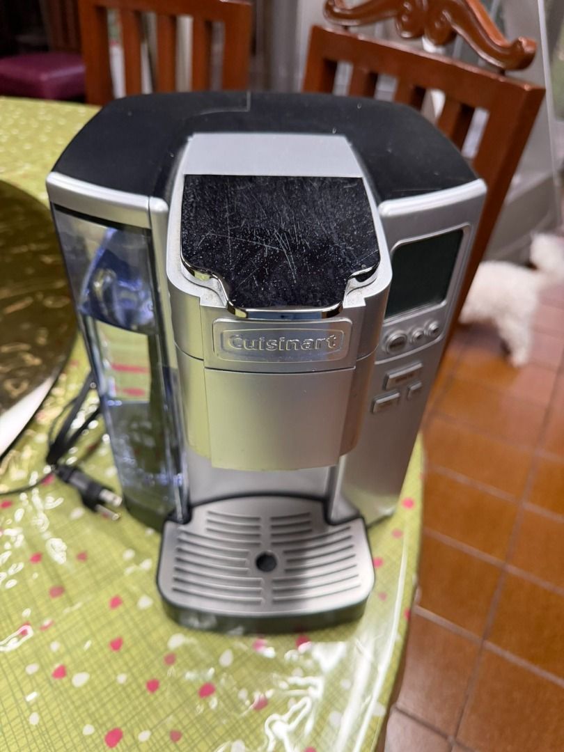 Cuisinart Keurig Coffee Maker (Category: Coffee Machines & Makers) located in Makati City. Submitted by kpesengco (Listing ID 1424986296, Image 1). Description: Keurig coffee maker features a water reservoir and a brew button. It has a silver and black color scheme. The coffee maker has a drip tray and a digital display. The power cord is included..