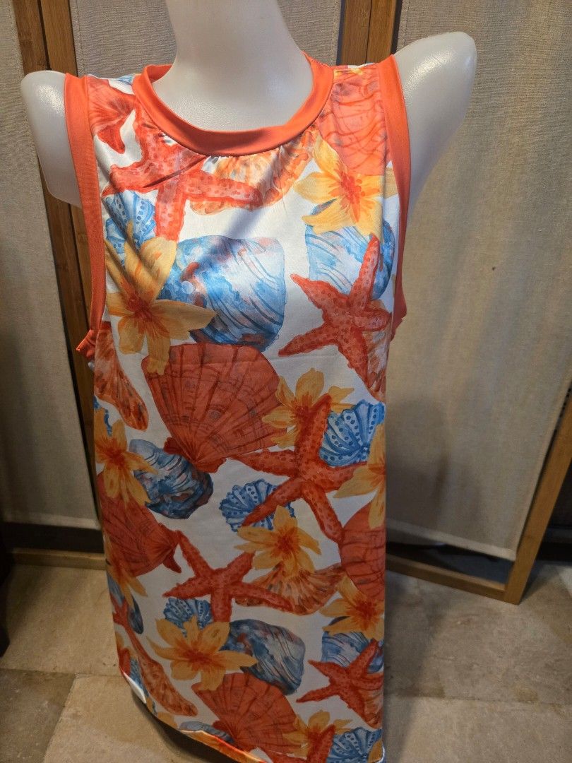 Dress - Seashell Print (Category: Dresses) located in Pasig City. Submitted by leildyne (Listing ID 1424980389, Image 2). Description: Dog tank top features a vibrant seashell print with starfish, shells, and flowers. It has an orange trim around the neck and armholes. The tank top is designed to fit a small dog..