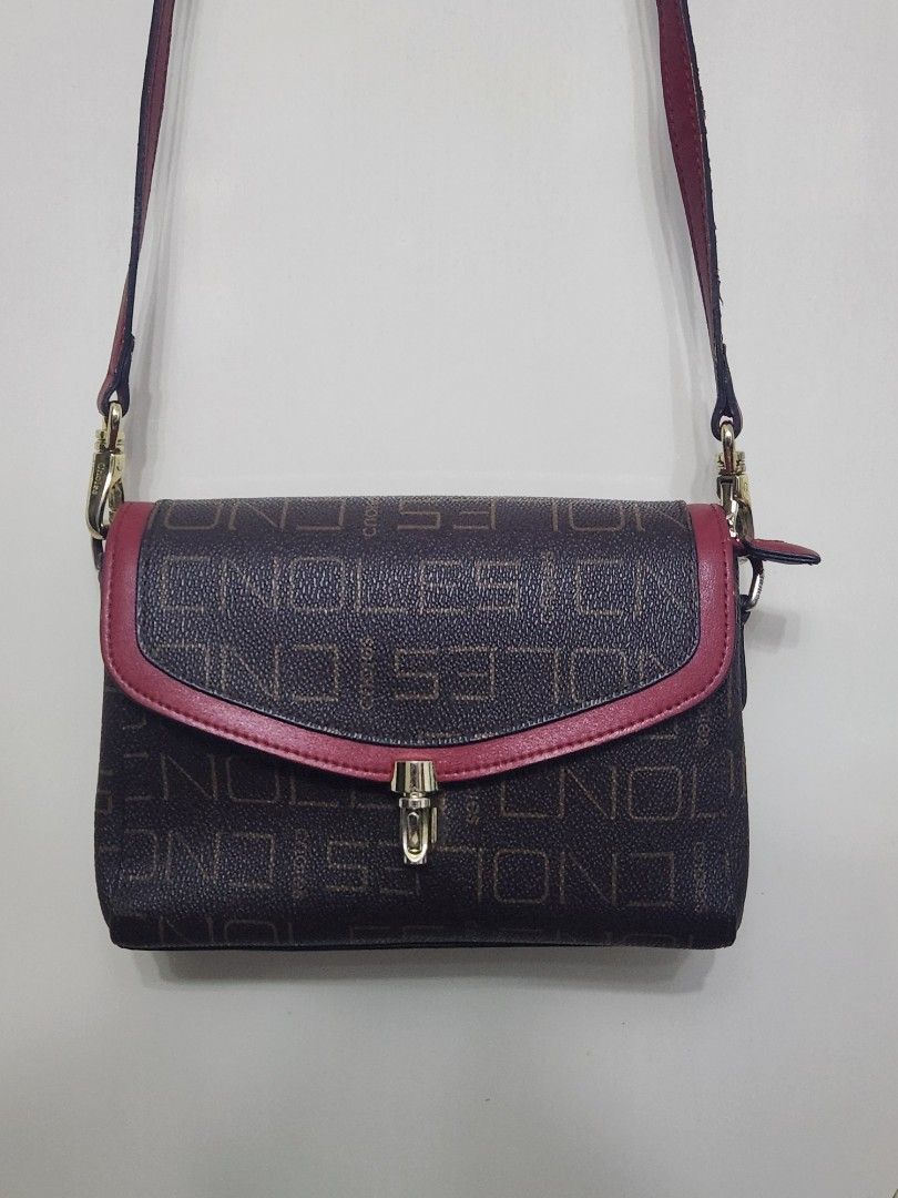 Endless Crossbody Bag with Red Accents (Category: Cross-body Bags) located in Tanza. Submitted by wearitagainph (Listing ID 1424958322, Image 1). Description: Stylish crossbody bag featuring a brown exterior with an all-over Endless pattern. It has red accents and a matching strap. The bag has a flap closure with a gold-tone clasp. Inside, there are multiple compartments, including a zippered pocket. The interior is red. The bag is designed with 