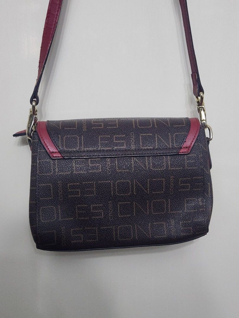 Endless Crossbody Bag with Red Accents (Category: Cross-body Bags) located in Tanza. Submitted by wearitagainph (Listing ID 1424958322, Image 2). Description: Stylish crossbody bag featuring a brown exterior with an all-over Endless pattern. It has red accents and a matching strap. The bag has a flap closure with a gold-tone clasp. Inside, there are multiple compartments, including a zippered pocket. The interior is red. The bag is designed with 