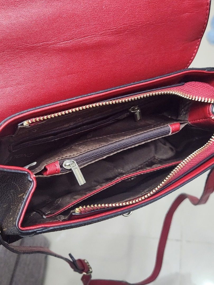 Endless Crossbody Bag with Red Accents (Category: Cross-body Bags) located in Tanza. Submitted by wearitagainph (Listing ID 1424958322, Image 3). Description: Stylish crossbody bag featuring a brown exterior with an all-over Endless pattern. It has red accents and a matching strap. The bag has a flap closure with a gold-tone clasp. Inside, there are multiple compartments, including a zippered pocket. The interior is red. The bag is designed with 