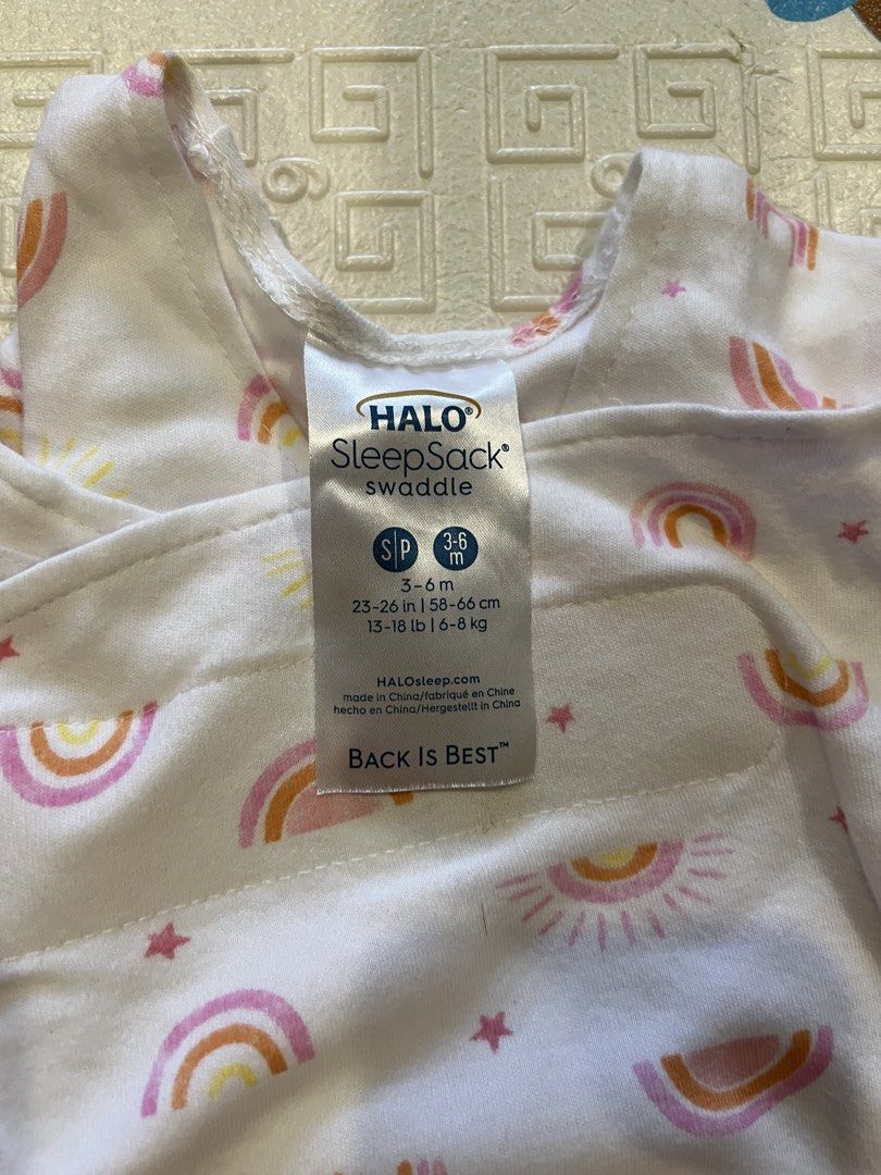 Halo SleepSack Swaddle - 3-6M (Category: Babies & Kids Fashion) located in Manila. Submitted by declutterforamari (Listing ID 1425056505, Image 2). Description: Halo SleepSack swaddle in size S (3-6 months). Features a cute rainbow and sun pattern. It has a zipper closure and adjustable swaddle wings. It has three ways to swaddle. The "Back is Best" message is also visible..