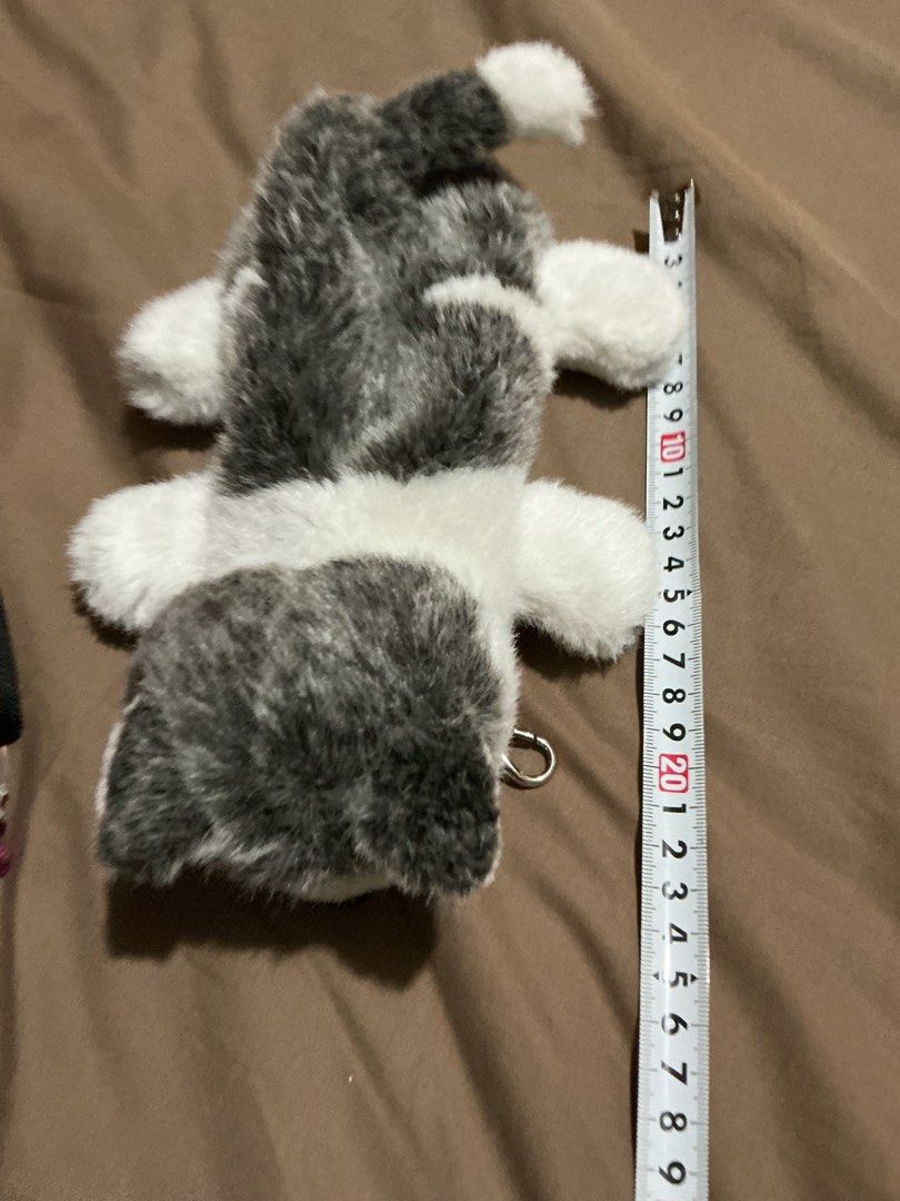 Husky Dog Plush Pouch (Category: Plushies & Soft Toys) located in Angeles City. Submitted by goodbuysathome (Listing ID 1425026983, Image 1). Description: Adorable husky dog plush pouch is perfect for storing small items. It features a zipper closure and a clip for easy attachment. The pouch is designed to look like a husky dog, with a black nose, blue eyes, and a fluffy white and gray fur. It is approximately 25cm long. Add sf 55 Gcash payment L