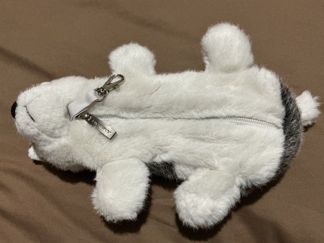 Husky Dog Plush Pouch (Category: Plushies & Soft Toys) located in Angeles City. Submitted by goodbuysathome (Listing ID 1425026983, Image 3). Description: Adorable husky dog plush pouch is perfect for storing small items. It features a zipper closure and a clip for easy attachment. The pouch is designed to look like a husky dog, with a black nose, blue eyes, and a fluffy white and gray fur. It is approximately 25cm long. Add sf 55 Gcash payment L