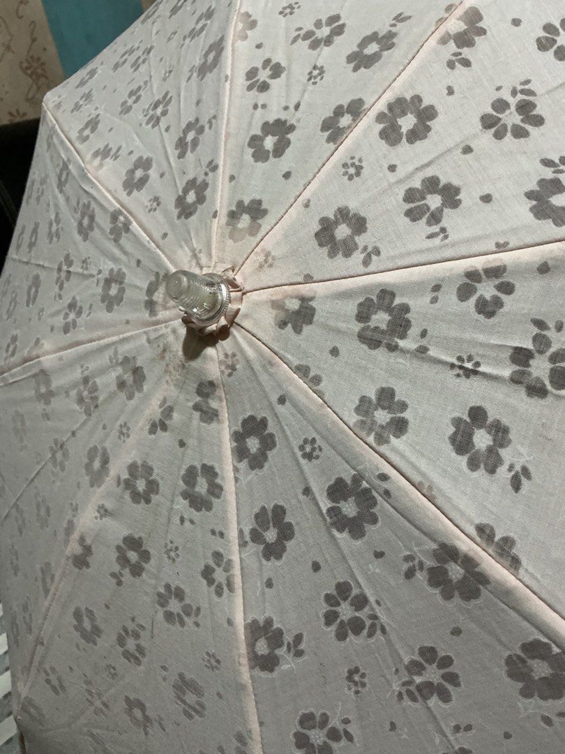 Metrocity Floral Lace Umbrella (Category: Umbrellas) located in Angeles City. Submitted by goodbuysathome (Listing ID 1425023027, Image 3). Description: Elegant Metrocity umbrella featuring a delicate floral pattern and lace trim. The umbrella is light pink with a clear handle and gold accents. It has a strap with the Metrocity logo. When open, the umbrella measures approximately 45cm in length. When closed, it measures approximately 25cm in leng