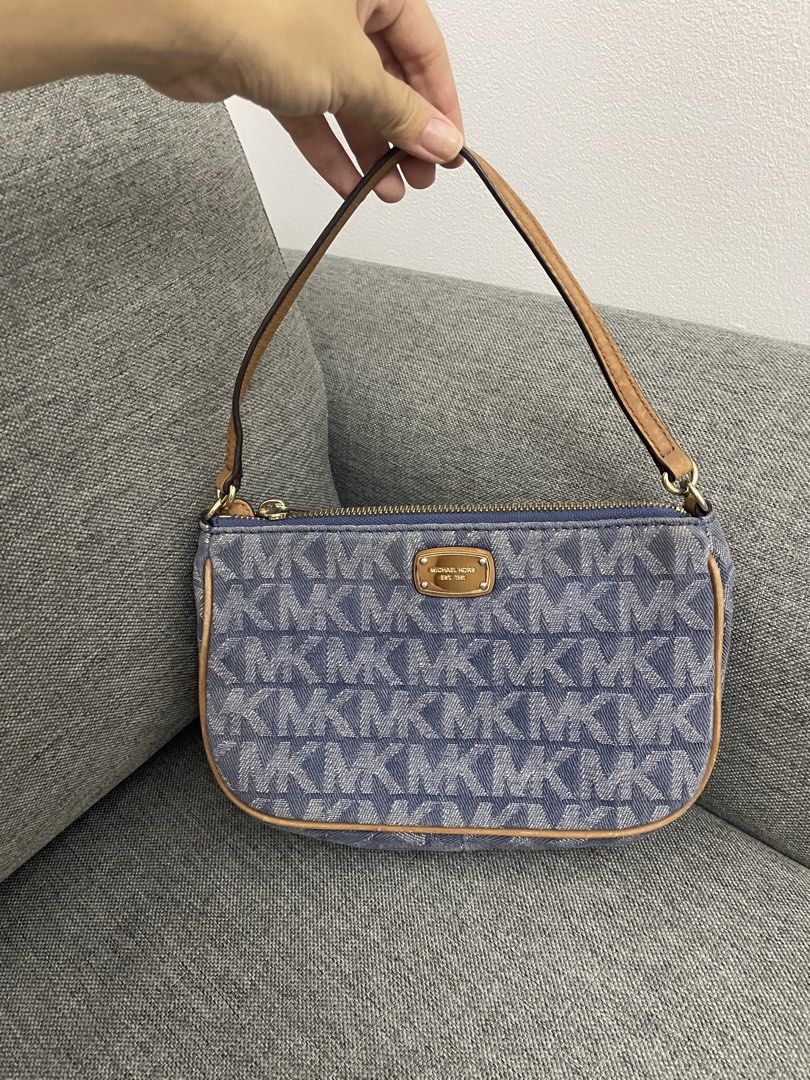 Michael Kors Denim Kili bag (Category: Luxury Bags & Wallets) located in Makati City. Submitted by chinyher (Listing ID 1425033332, Image 1). Description: Authentic Michael Kors handbag in denim material. Features a top handle and a detachable strap. The bag has a gold-tone zipper and hardware. The interior includes multiple compartments and the Michael Kors logo. The exterior displays the MK logo pattern. Includes a small gold-tone plaque with t