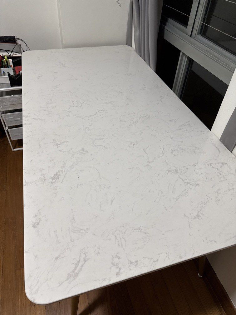 Dining Table (Category: Tables & Sets) located in Singapore. Submitted by greenlifetime (Listing ID 1405947341, Image 2). Description: - White marble-look dining table with gold legs - Suitable for small to medium dining areas Dimension: 160cm x 80cm x 75cm Size good for 4-6 pax Listing is for dining table. Been with me for over 1 year. In good condition. Welcome to view actual item prior to purchase Family has no pets and non-smoking household. 