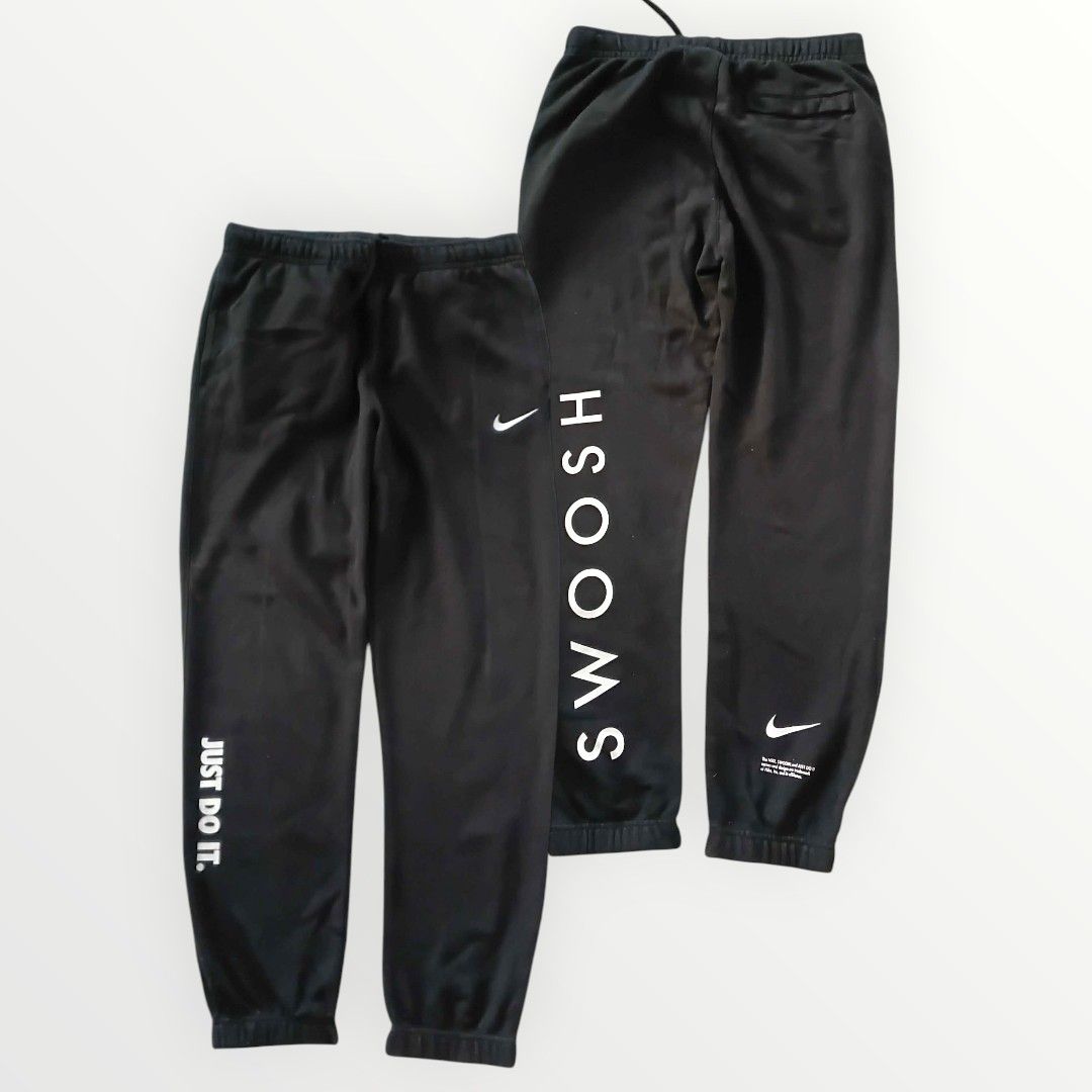 Nike Swoosh Sweatpants XL (Category: Joggers) located in Gapan. Submitted by head.haven (Listing ID 1424982090, Image 1). Description: Black Nike sweatpants with "Swoosh" printed on the side. Features the Nike logo and "Just Do It." on the front. The size is XL. Made in China. Standard fit. Includes a drawstring at the waist. The sweatpants have a back pocket..