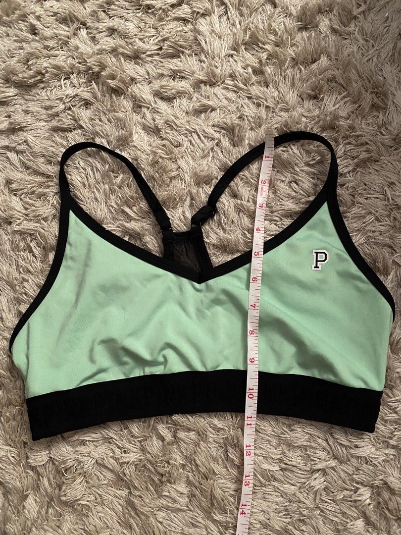 Pink Victoria's Secret Ultimate Sports Bra (Category: Activewear) located in Las Pinas. Submitted by sherylandmargaux (Listing ID 1425018710, Image 2). Description: Pink Victoria's Secret Ultimate sports bra in mint green and black. Features a racerback design with a mesh panel at the back. The bra has a black band at the bottom and a small "P" logo on the front. Size L, fits C80, D80, A85, C85. Made in Vietnam..