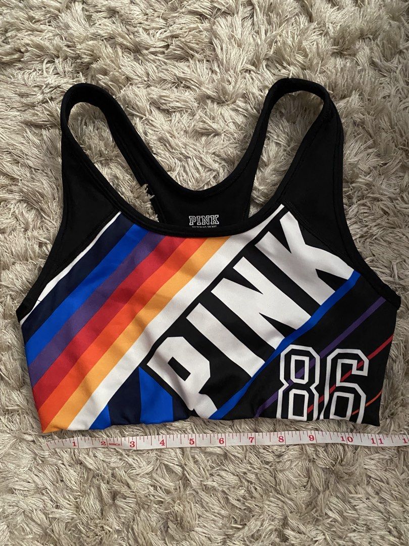 Pink Victoria's Secret Ultimate Sports Bra (Category: Activewear) located in Las Pinas. Submitted by sherylandmargaux (Listing ID 1425018955, Image 2). Description: Pink Victoria's Secret Ultimate sports bra. Features a black and colorful design with the word "PINK" and the number "86". The bra has a racerback style. The size is B75 (equivalent to a size S/D, AA75, A75). Made in Sri Lanka. The material is 88% polyester and 12% elastane..