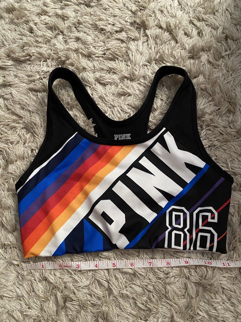 Pink Victoria's Secret Ultimate Sports Bra (Category: Activewear) located in Las Pinas. Submitted by sherylandmargaux (Listing ID 1425018955, Image 1). Description: Pink Victoria's Secret Ultimate sports bra. Features a black and colorful design with the word "PINK" and the number "86". The bra has a racerback style. The size is B75 (equivalent to a size S/D, AA75, A75). Made in Sri Lanka. The material is 88% polyester and 12% elastane..