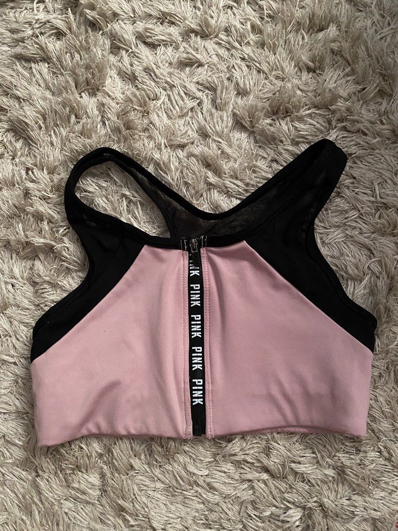 Pink Victoria's Secret Ultimate Sports Bra XS (Category: Activewear) located in Las Pinas. Submitted by sherylandmargaux (Listing ID 1425019066, Image 1). Description: Pink Victoria's Secret Ultimate sports bra in size XS. Features a front zipper with "PINK" printed on it. The bra has a pink and black color scheme with mesh detailing on the back and sides. The bra is unlined. Measurements are provided in the images..