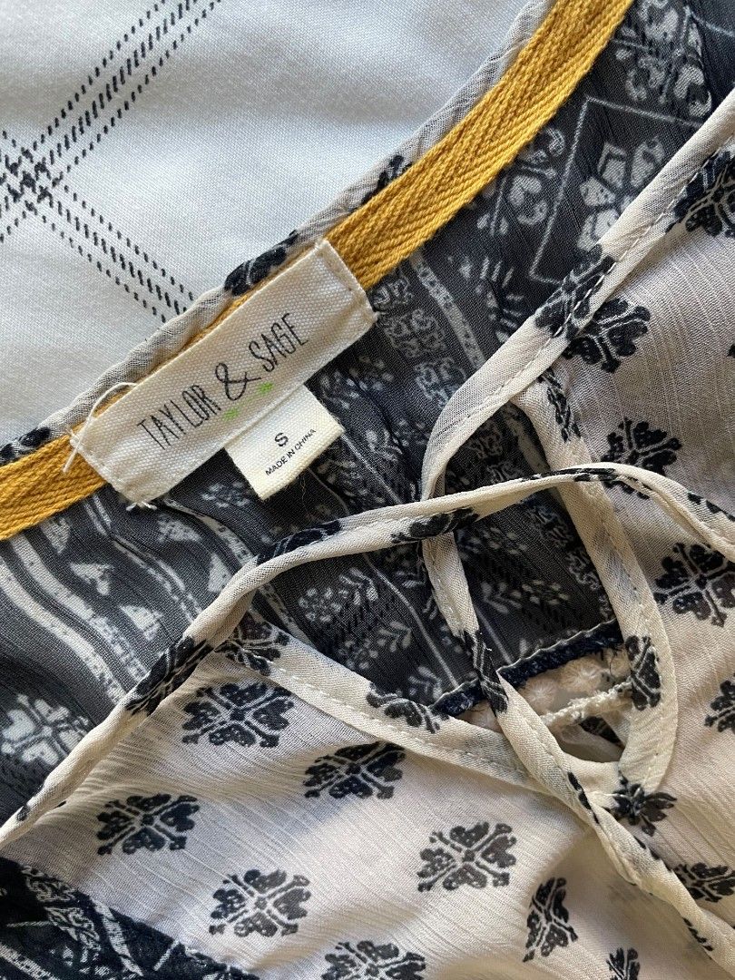 Taylor & Sage Bohemian Y2K Boho Blouse - Size S (Category: Blouses) located in Mandaue City. Submitted by midnight.skyes (Listing ID 1424985437, Image 3). Description: - Taylor & Sage long sleeve blouse - bought in the US - Cream and navy blue bohemian design - Size: Small - V-neckline with tie strings - sheer light-weight material - high quality - white lace detailing - features flared sleeves and flared trim - Boho/y2k style.