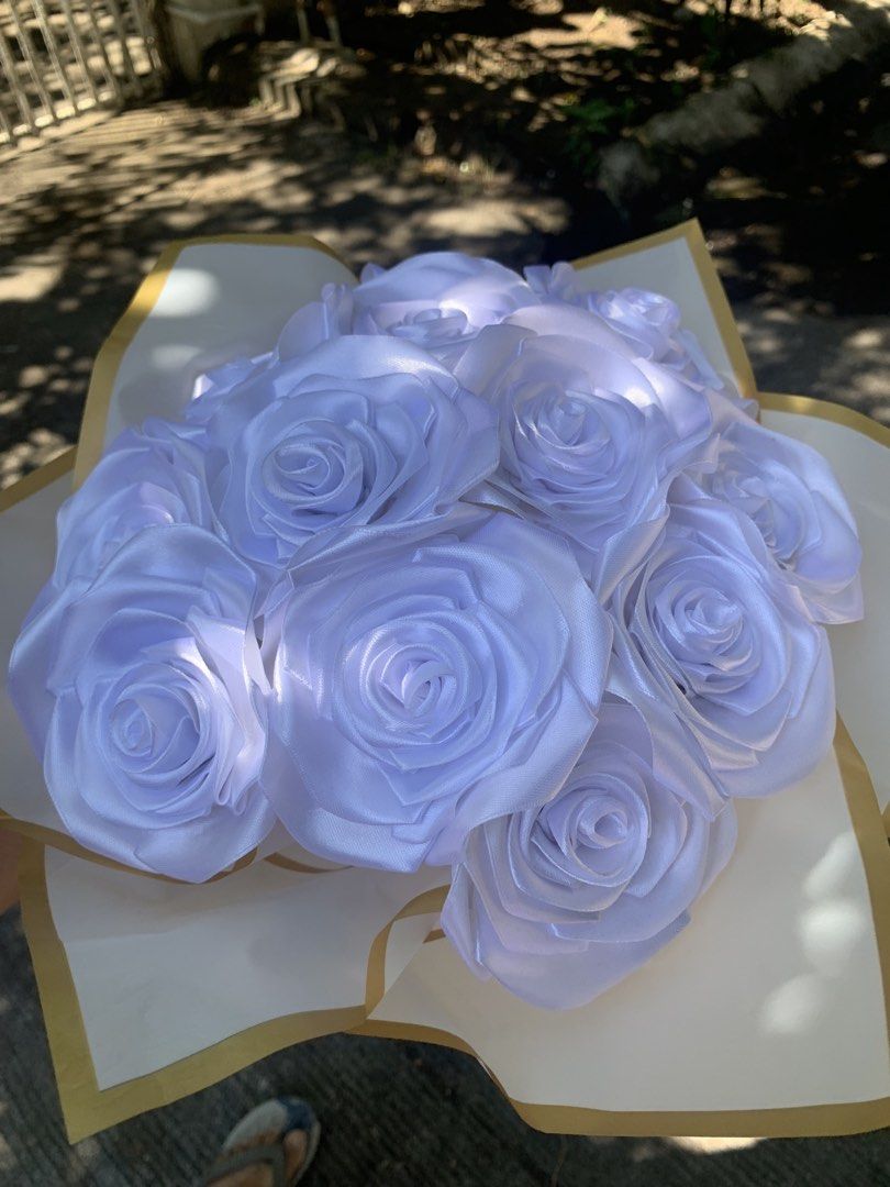 White Satin Rose Bouquet (Category: Flowers & Bouquets) located in Manila. Submitted by foreverble80256 (Listing ID 1424896430, Image 2). Description: Beautiful bouquet of white satin roses. The roses are arranged in a bouquet and wrapped in white paper with gold trim. A white ribbon is tied around the stems. Perfect for gifts or decorations. Dozen of roses All colors available Has light battery operated.