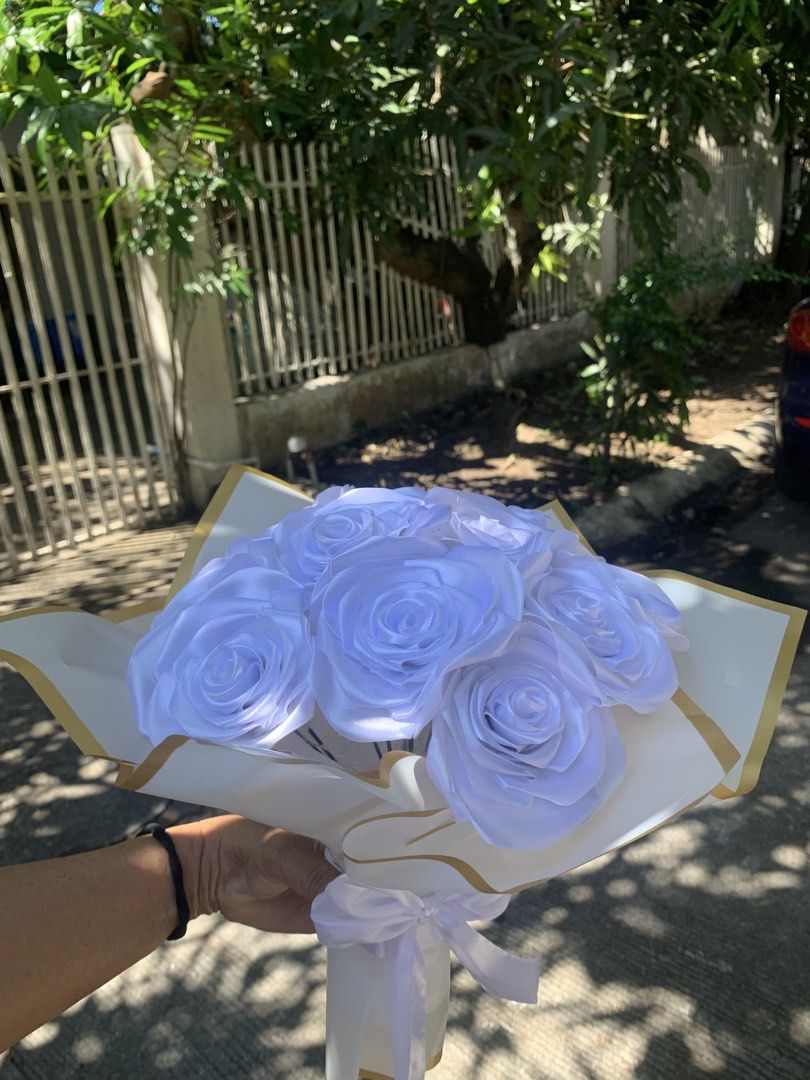 White Satin Rose Bouquet (Category: Flowers & Bouquets) located in Manila. Submitted by foreverble80256 (Listing ID 1424896430, Image 3). Description: Beautiful bouquet of white satin roses. The roses are arranged in a bouquet and wrapped in white paper with gold trim. A white ribbon is tied around the stems. Perfect for gifts or decorations. Dozen of roses All colors available Has light battery operated.