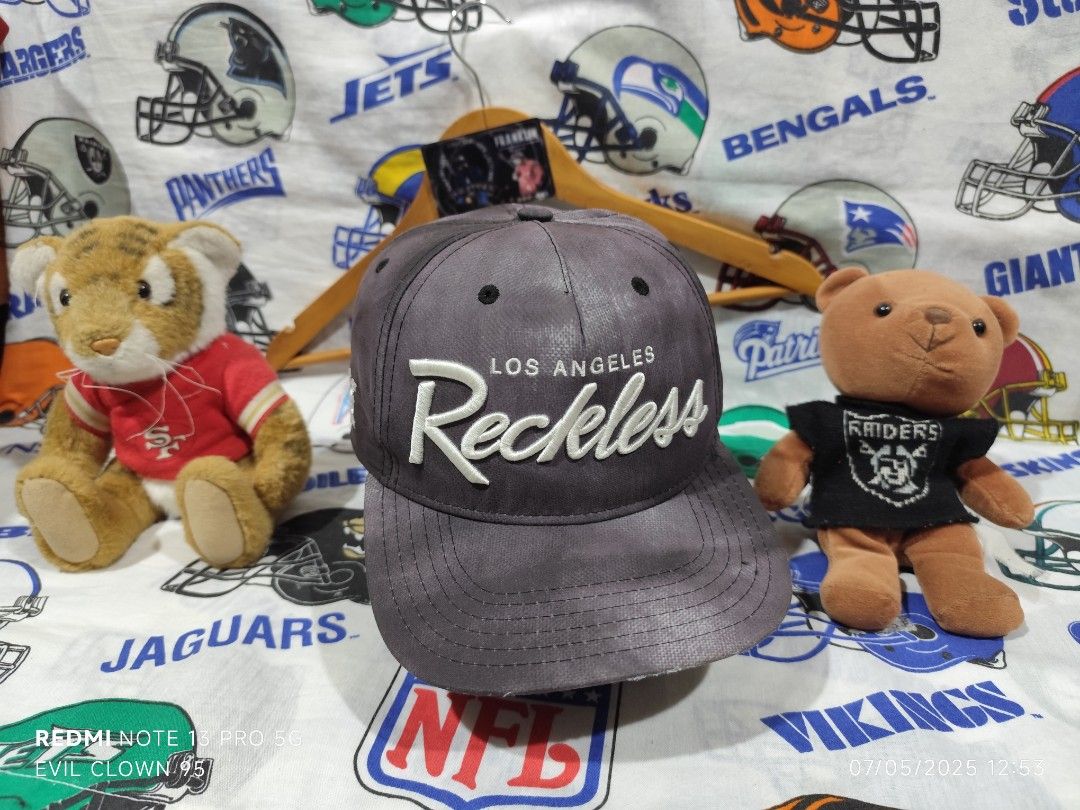 Y&R Los Angeles Reckless Cap (Category: Caps & Hats) located in Baguio. Submitted by FRANKLIN (Listing ID 1424991987, Image 1). Description: Cap features the "Los Angeles Reckless" design. It has a snapback closure and the Y&R logo on the side. The cap's interior has the brand name printed along the seams. The cap is a dark grey color..