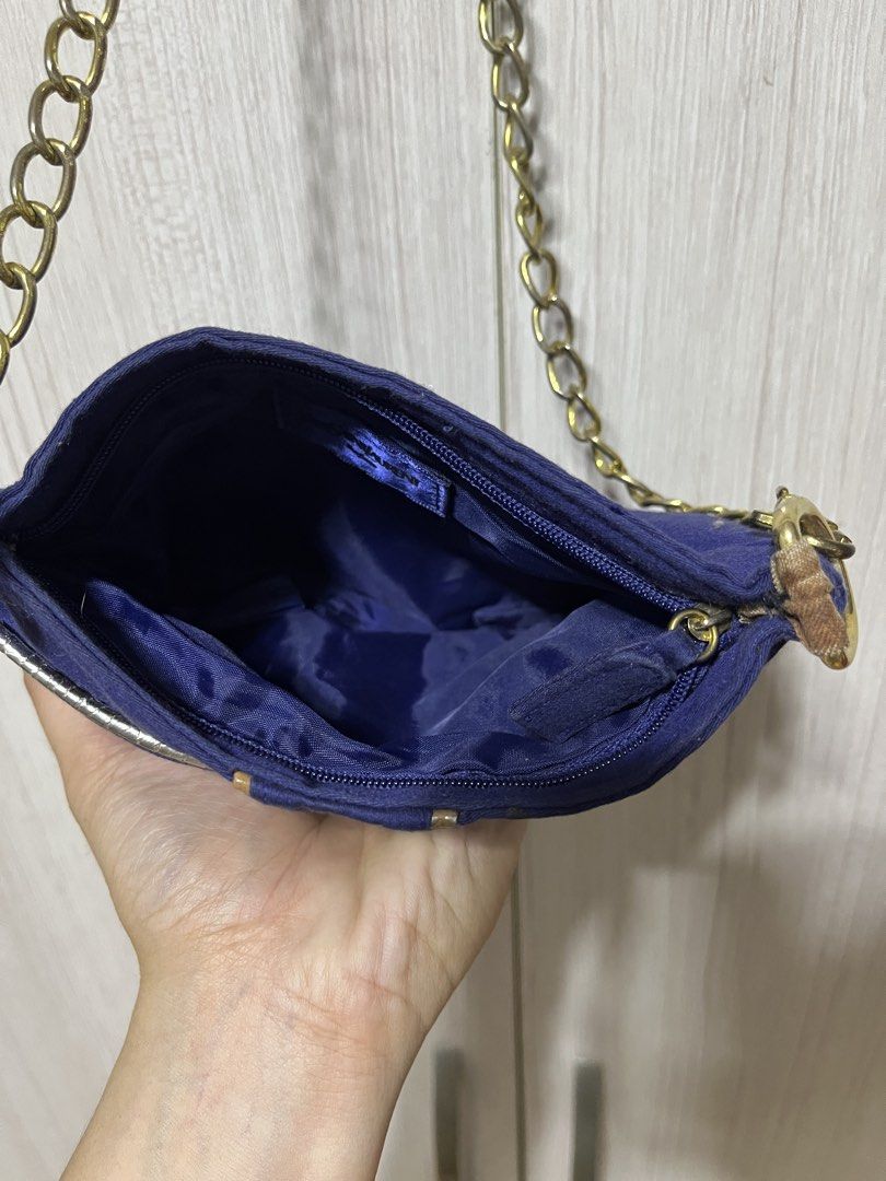 YSL Yves Saint Laurent Chain Bag (Category: Luxury Bags & Wallets) located in Bulacan. Submitted by sef19 (Listing ID 1424904151, Image 3). Description: Navy blue YSL chain bag with gold-tone chain. Features a rectangular shape with a gold trim. The interior is also navy blue. The bag has a YSL logo on the front. The composition tag indicates the bag is made in China..