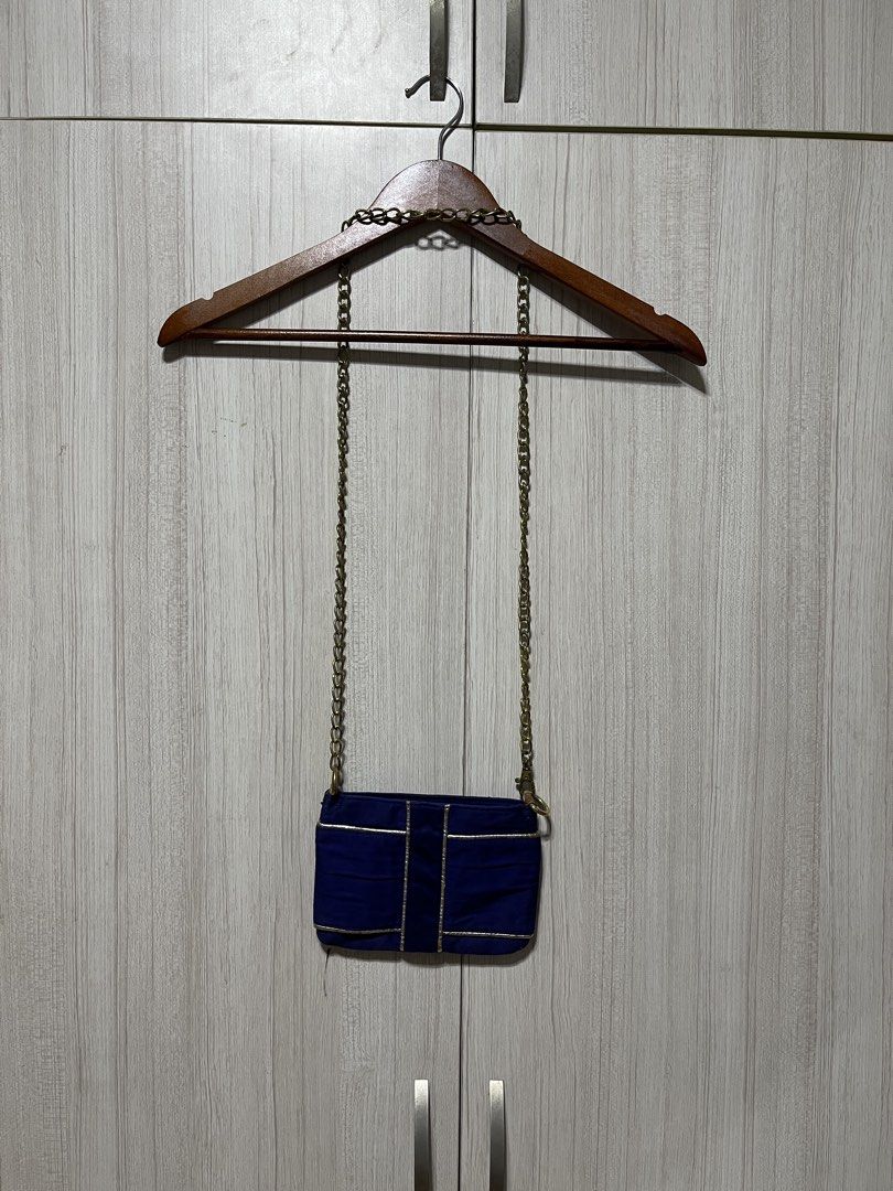 YSL Yves Saint Laurent Chain Bag (Category: Luxury Bags & Wallets) located in Bulacan. Submitted by sef19 (Listing ID 1424904151, Image 1). Description: Navy blue YSL chain bag with gold-tone chain. Features a rectangular shape with a gold trim. The interior is also navy blue. The bag has a YSL logo on the front. The composition tag indicates the bag is made in China..