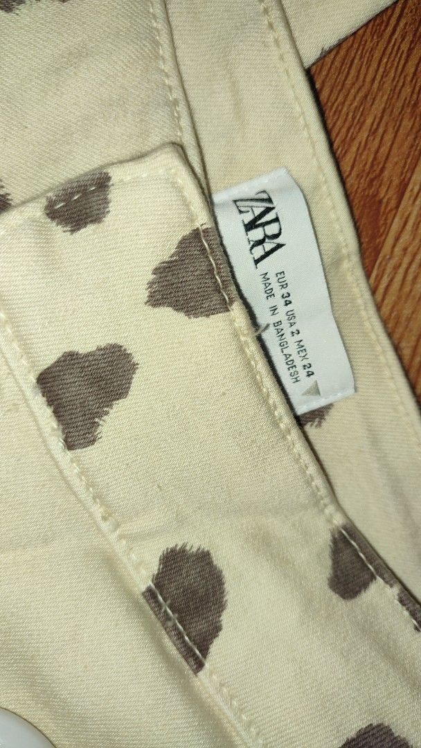 Zara Cow Print Flare Pants (Category: Jeans) located in Caloocan City. Submitted by faesrie (Listing ID 1424983746, Image 2). Description: waist - 24 inches length - 44 inches Stylish flare pants from Zara. Features a unique cow print design. Made in Bangladesh. The pants have a high waist and a flared leg opening. The size is EUR 34, USA 2, MEX 24. Perfect for adding a statement piece to your wardrobe..