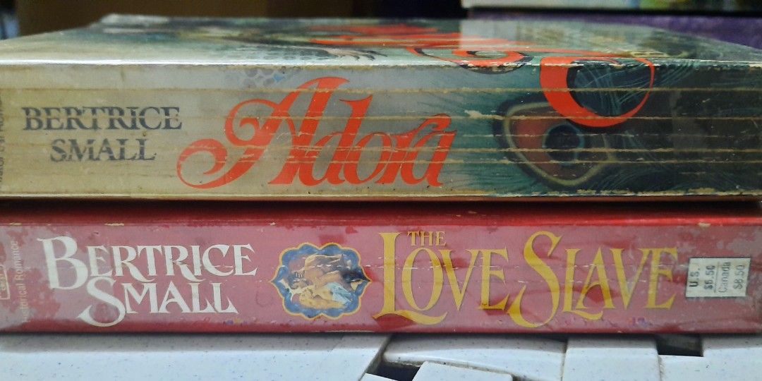 Bertrice Small Books - The Love Slave & Adora (Category: Storybooks) located in Makati City. Submitted by fiestypam (Listing ID 1425066433, Image 2). Description: Two vintage books by Bertrice Small: "The Love Slave" and "Adora." Both books feature eye-catching cover art. "The Love Slave" has a red cover with a couple embracing. "Adora" has a cover with a woman and a man. Perfect for collectors or fans of historical romance. Love Slave P150 Adora
