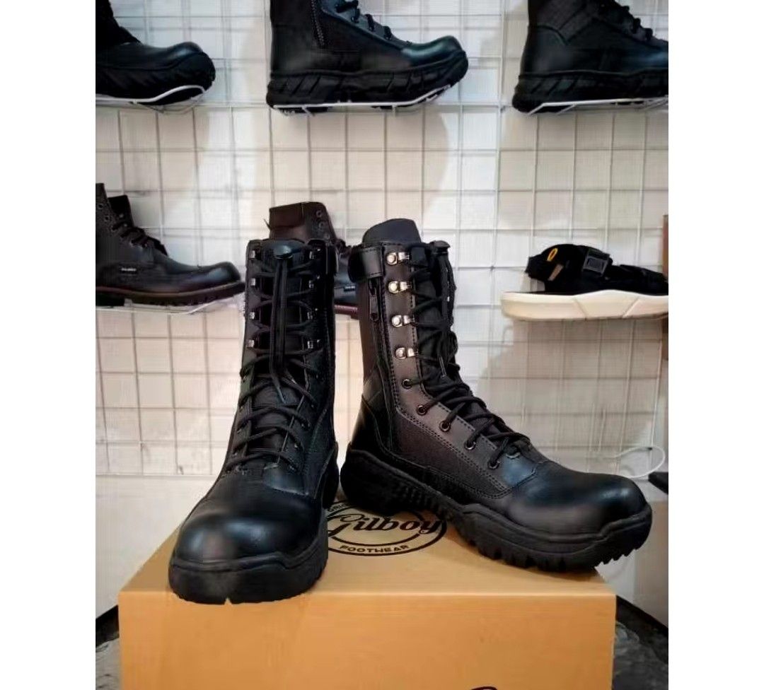 Black Combat Boots (Category: Boots) located in Marikina City. Submitted by tattooednurse. (Listing ID 1425125279, Image 1). Description: Black combat boots with laces and a side zipper. The boots have a thick sole and a high-top design. The brand name "Gilboy" is visible on the box. The boots appear to be made of leather or a similar material. They are suitable for various outdoor activities..