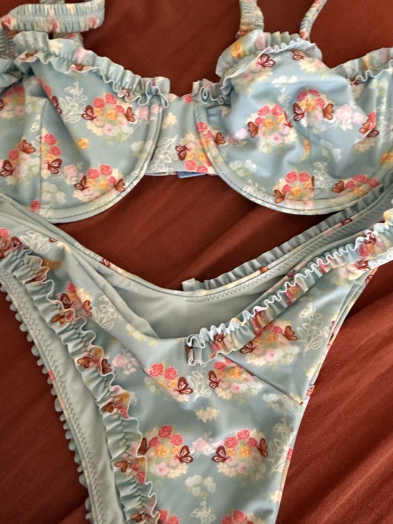 Blackbough Swim Floral Bikini Set (Category: Bikinis & Swimsuits) located in Mandaluyong City. Submitted by ndclutters (Listing ID 1425208207, Image 3). Description: Blackbough Swim bikini set featuring a blue floral print with butterfly accents. The set includes a top and a bottom with ruffle detailing. The bottom is a size S. The bikini is light blue in color..
