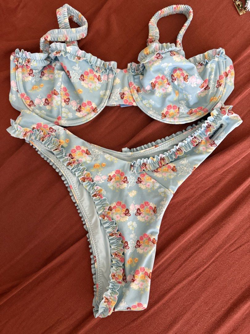 Blackbough Swim Floral Bikini Set (Category: Bikinis & Swimsuits) located in Mandaluyong City. Submitted by ndclutters (Listing ID 1425208207, Image 1). Description: Blackbough Swim bikini set featuring a blue floral print with butterfly accents. The set includes a top and a bottom with ruffle detailing. The bottom is a size S. The bikini is light blue in color..