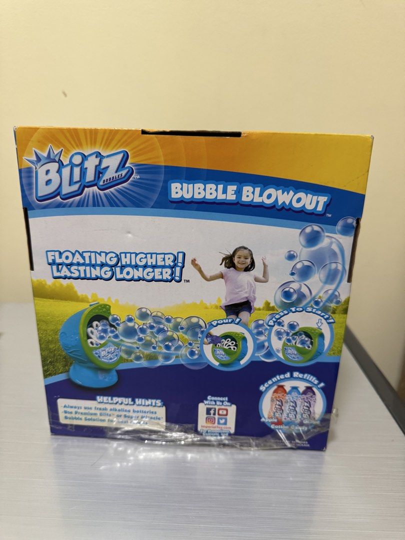 Blitz Bubbles Bubble Blowout (Category: Kids Toys) located in San Juan City. Submitted by biancaong10 (Listing ID 1425193798, Image 2). Description: Blitz Bubbles Bubble Blowout machine is designed to create bubbles. It includes the bubble machine and a bottle of bubble solution. The box indicates it is for ages 3+. It is designed to make bubbles that float higher and last longer. The machine is green and blue..