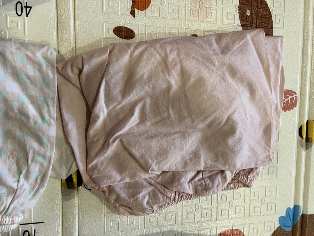 Bundle Fitted Crib Sheets Set (Category: Bedding & Towels) located in Manila. Submitted by declutterforamari (Listing ID 1425056967, Image 3). Description: Set of fitted crib sheets in various colors and patterns. Includes floral, gingham, solid pink, rust, and rainbow/leaf designs. All sheets have elastic edges and can fit any mattress in a crib. .